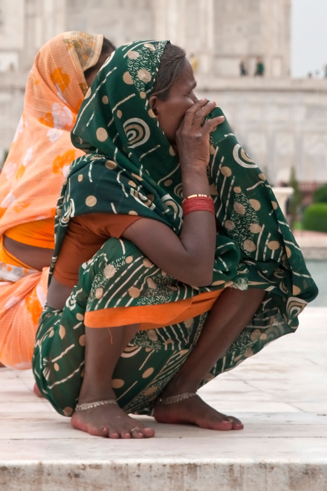 An Indian woman resting in a natural flat-footed deep squat