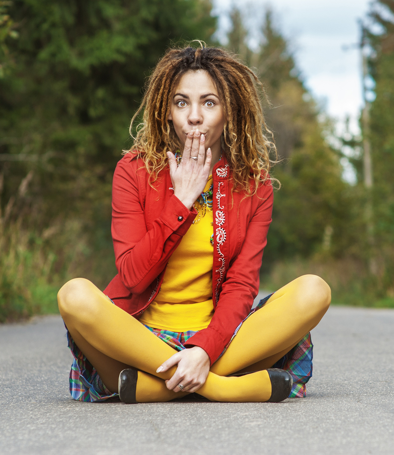 A young, colorful woman with dreadlocks in shock.