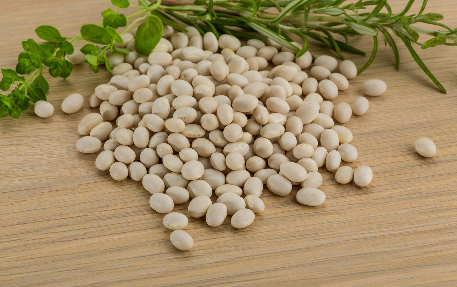 Raw white beans on a kitchen board