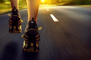 person running down road for aerobic exerise