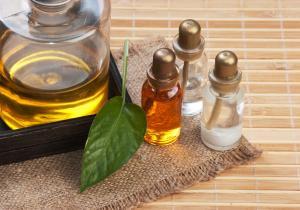 three small bottles of natural oils and large bottle to the left