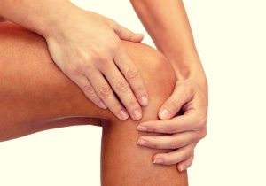 massaging castor oil into sore knee joint