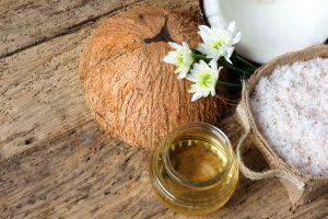 jar of coconut oil with coconut in background