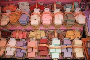 Assorted bars of soap in baskets on a market in the Provence, France