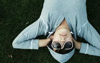 A person resting on grass.